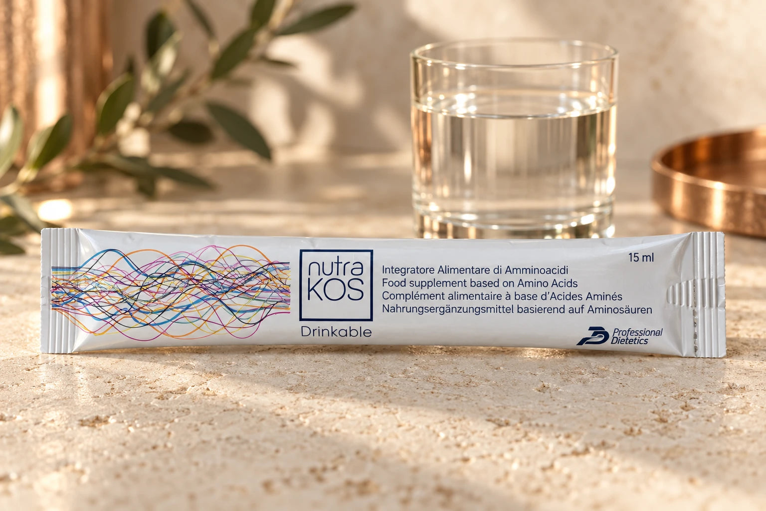 Nutrakos sachet with its complete printed label beside a glass of water